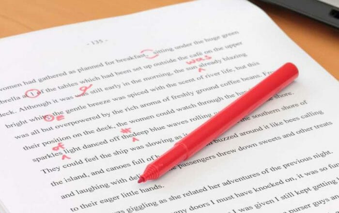 Pen and paper with red corrections